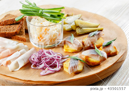 Sandwich on fried potatoes with herring, green onion. Tasty appetizer with sauerkraut, pickled Sandwich on fried potatoes with herring, green onion. Tasty appetizer with sauerkraut, pickled 43501557