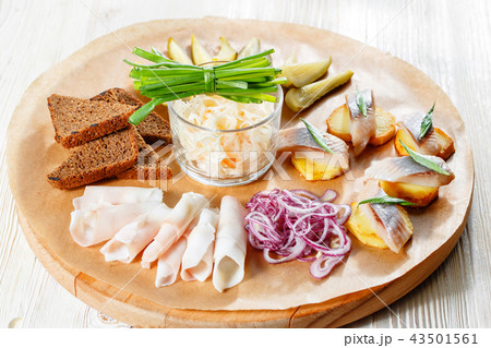 Sandwich on fried potatoes with herring, green onion. Tasty appetizer with sauerkraut, pickled 43501561