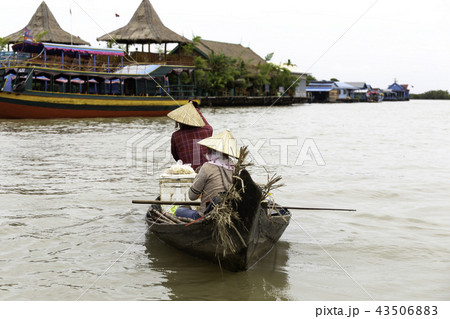 Two women selling food in a boat 43506883