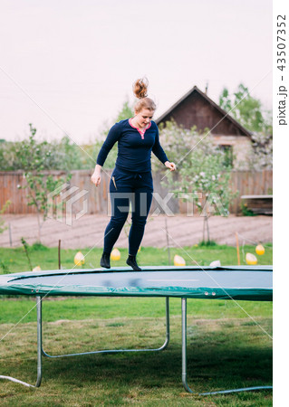 Young Caucasian Beautiful Plus Size Woman Girl Jumping On Trampoline Young Caucasian Beautiful Plus Size Woman Girl Jumping On Trampoline 43507352