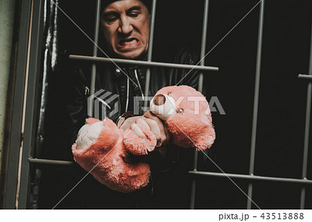 Man In Handcuffs Behind Bars In A Police Station. 43513888