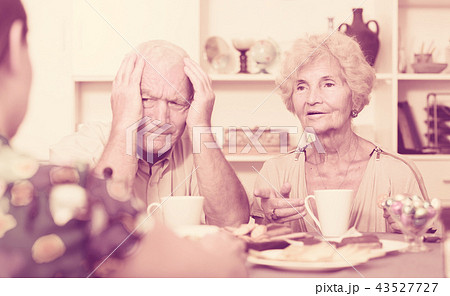 Stressed senior couple having conversation with female Stressed senior couple having conversation with female 43527727