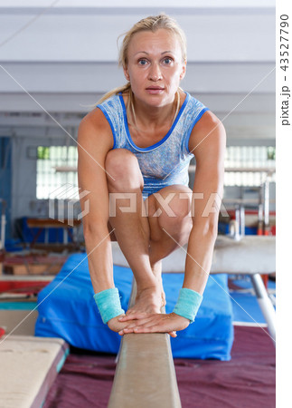 Woman doing choreographic elements on beam Woman doing choreographic elements on beam 43527790
