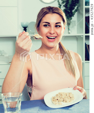 Sporty girl is enjoying breakfast with oatmeal porridge 43527929
