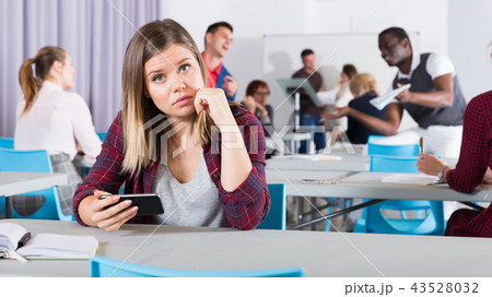 Frustrated woman student with phone Frustrated woman student with phone 43528032