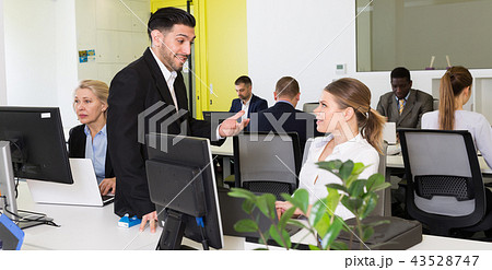 Coworkers flirting in modern office 43528747