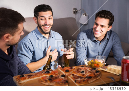 Three men talking and laughing at home Three men talking and laughing at home 43528930