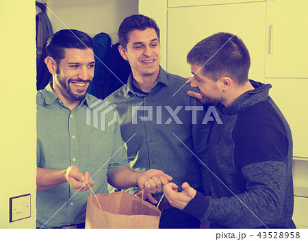 Man meeting male friends at home 43528958
