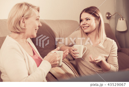 Mom and adult daughter talking 43529067