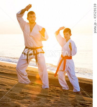 Man and boy practising karate Man and boy practising karate 43529139