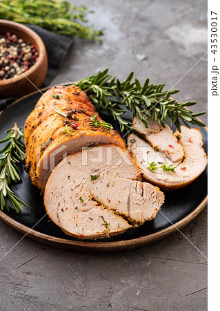 Stuffed turkey breast with baked vegetables and spices on a black background. Stuffed turkey breast with baked vegetables and spices on a black background. 43530017