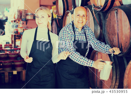 man and woman holding wine vessels 43530955