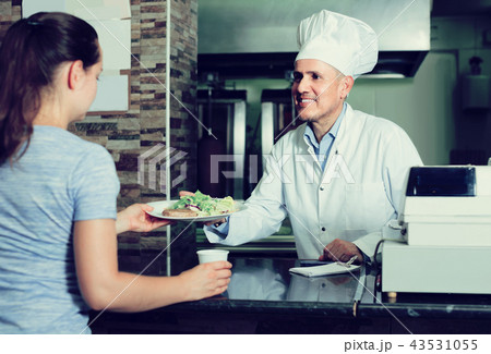 man cook serving fresh kebab dish to customer on counter in fas man cook serving fresh kebab dish to customer on counter in fas 43531055