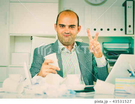 Cheerful businessman enjoying the excellent results Cheerful businessman enjoying the excellent results 43531527