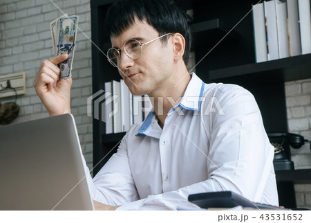 Business man counting dollar bill money in office Business man counting dollar bill money in office 43531652