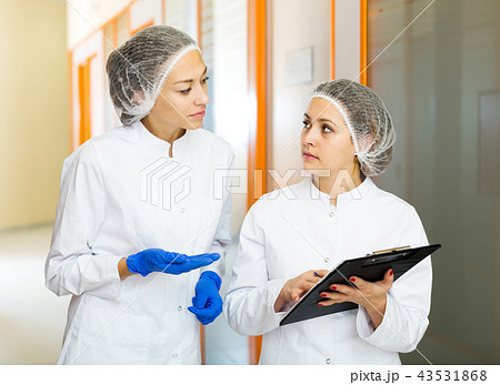 Woman doctors talking about beauty procedures Woman doctors talking about beauty procedures 43531868