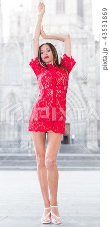 portrait of sexy young woman in red dress walking in the old city 43531869