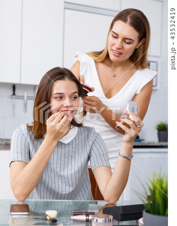 Friends talking and applying make up 43532419
