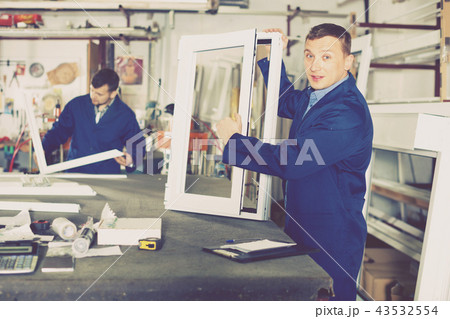 Workmen inspecting PVC manufacturing output in workshop Workmen inspecting PVC manufacturing output in workshop 43532554