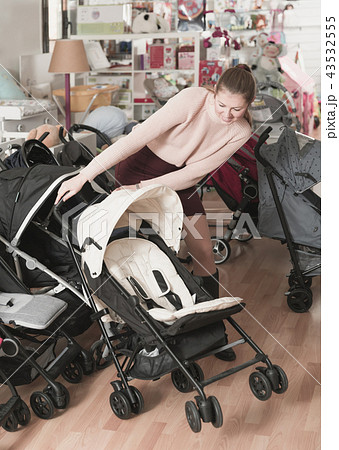 girl choosing carriage for kids girl choosing carriage for kids 43532555