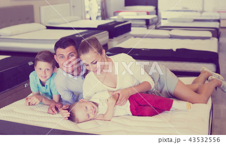 Family choosing mattress in store Family choosing mattress in store 43532556