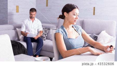 Happy girl painting nails in living room Happy girl painting nails in living room 43532606