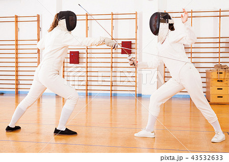 female athletes practicing movements at fencing battle 43532633