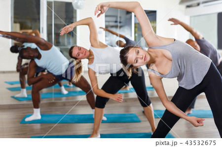 Adult people exercising during yoga class Adult people exercising during yoga class 43532675