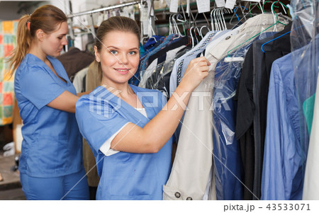 Female worker inspecting clothing 43533071