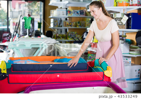 pregnant woman looking for playpen 43533249