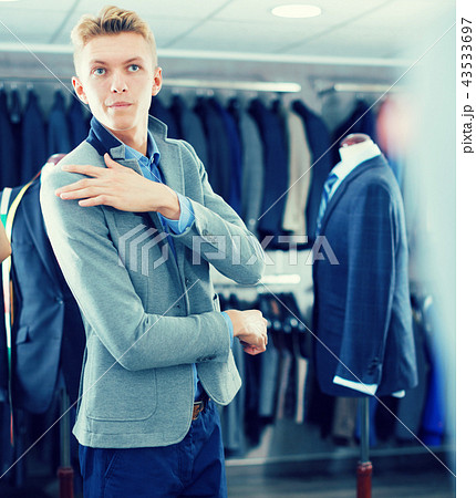 man costumer trying jacket in mirror indoors man costumer trying jacket in mirror indoors 43533697