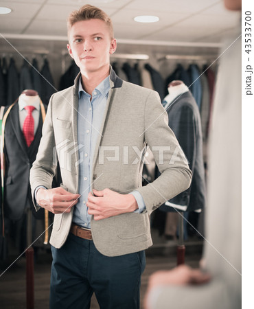 Man purchaser trying jacket in the dress shop 43533700