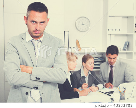 Business team solving problems with upset man foreground 43533705