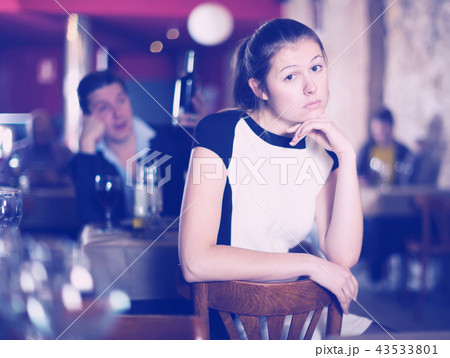 Woman unhappy because her boyfriend drinking in cafe Woman unhappy because her boyfriend drinking in cafe 43533801