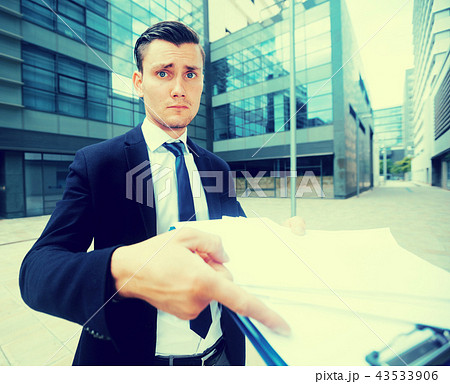 Serious manager is standing upset near office Serious manager is standing upset near office 43533906