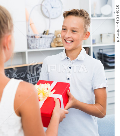 Girl is congratulation friend with his birthday 43534010