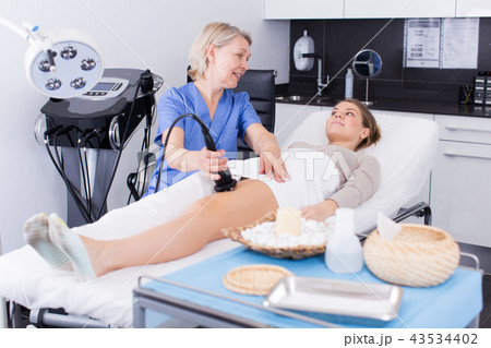 Cosmetician performing hardware body treatment Cosmetician performing hardware body treatment 43534402