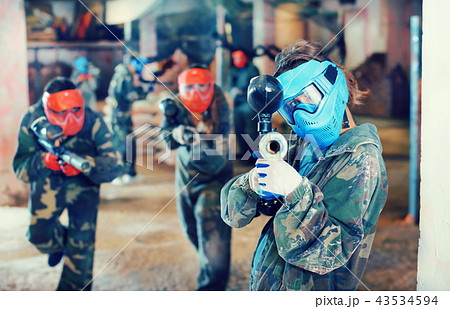 Player aiming in opponents in paintball field Player aiming in opponents in paintball field 43534594