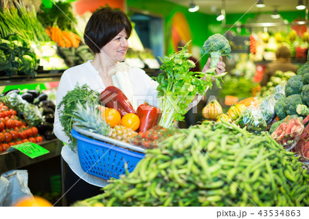 Adult female taking vegetables with basket Adult female taking vegetables with basket 43534863