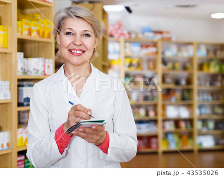 Nice female seller checking assortment of care products 43535026