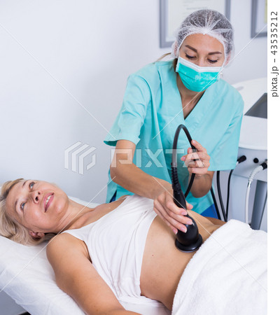 Woman receiving cryoliposuction 43535212