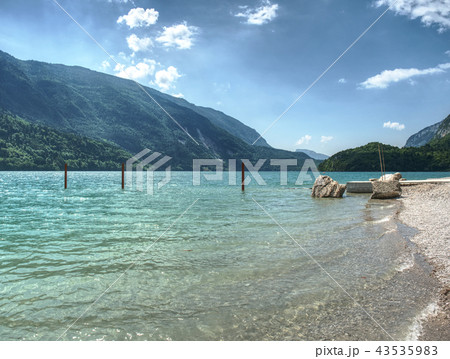 Stony beach lake with stack of sharp boulders. Stony beach lake with stack of sharp boulders. 43535983
