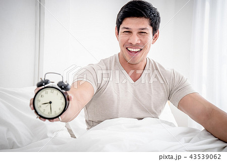Man stop alarm clock with optimistic ready feeling Man stop alarm clock with optimistic ready feeling 43539062