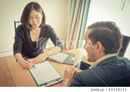 Woman signing on a contract for job or business ag 43539133