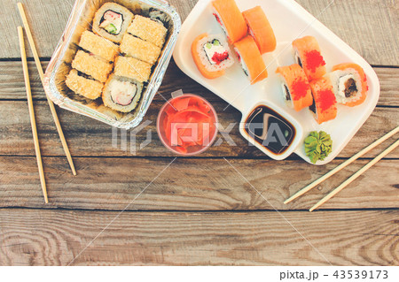 Rolls, wasabi, soy sauce, ginger on table.   43539173