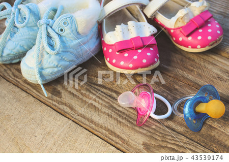 Baby shoes and pacifiers pink and blue Baby shoes and pacifiers pink and blue 43539174