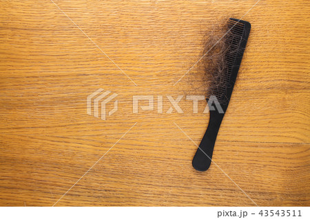 Fallen hair on comb on table. Top view. Fallen hair on comb on table. Top view. 43543511
