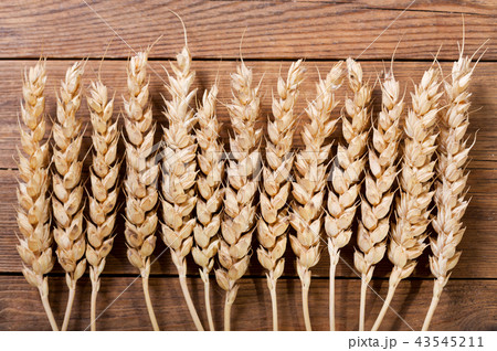 wheat ears on wooden background 43545211