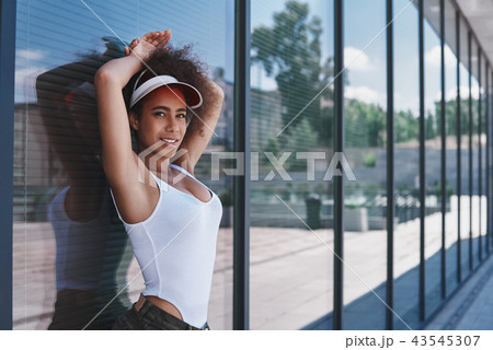Young woman in visor free style on the street leaning on window  43545307