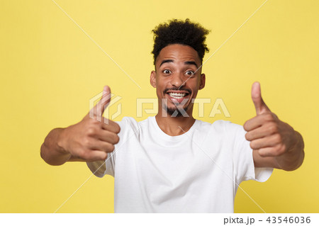Happy African-American Businessman isolated on yellow background. 43546036